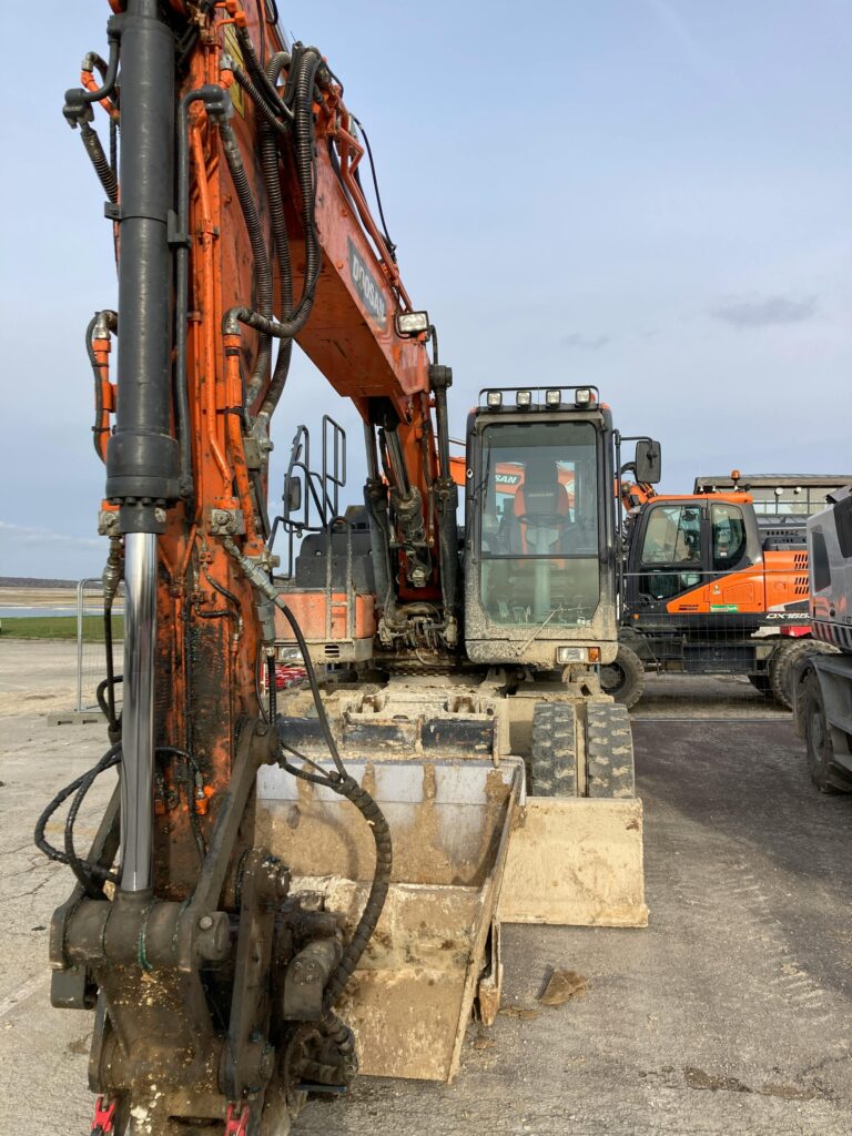 Close-up of an excavator at a construction site, displaying industrial strength and precision.
